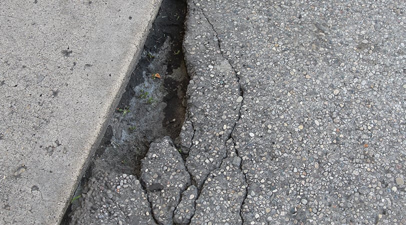 Concrete pavement with cracks on the side