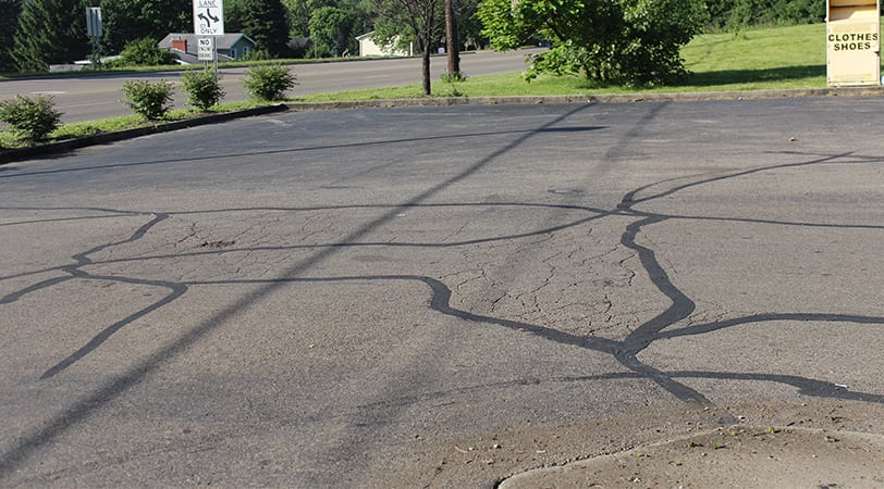 Parking lot of a gas station with cracks