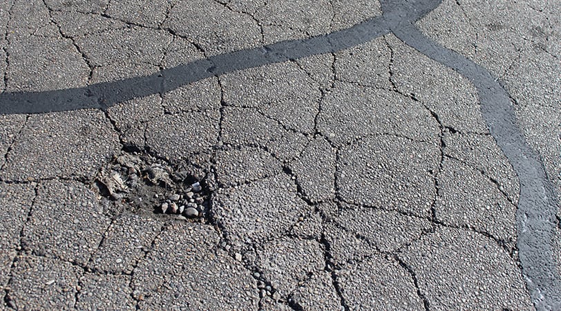 A Gas Station Road With Cracks on the Road
