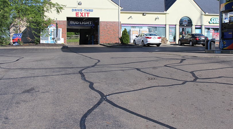 A Gas Station Road With Cracks on the Path